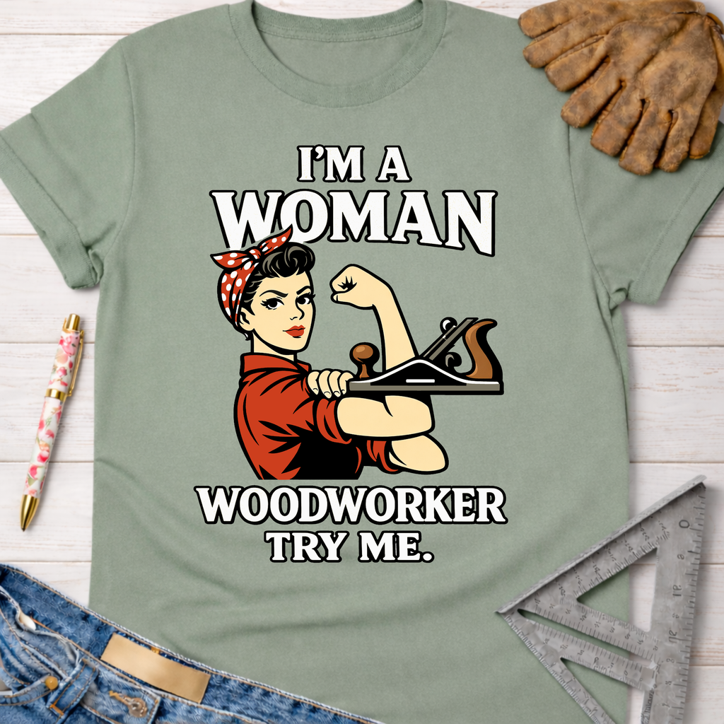 Sage green women's Rosie the Riveter "I'm A Woman Woodworker Try Me" graphic tee. Sawdust & Ponytails.