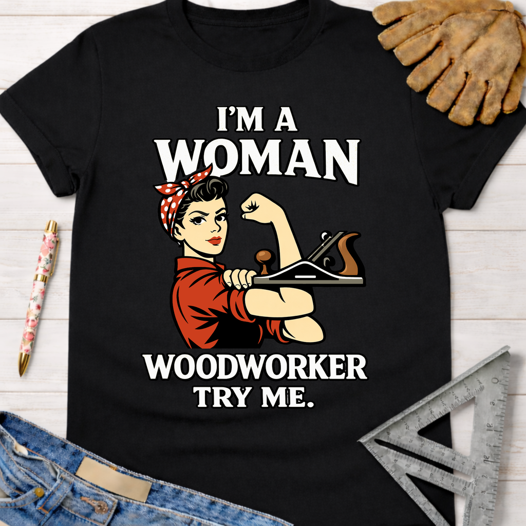 Black cotton "I'm A Woman Woodworker Try Me" graphic tee with Rosie the Riveter holding a plane. Women's funny woodworking graphic tee shirt for female woodworkers, makers, and DIY builders — Sawdust & Ponytails