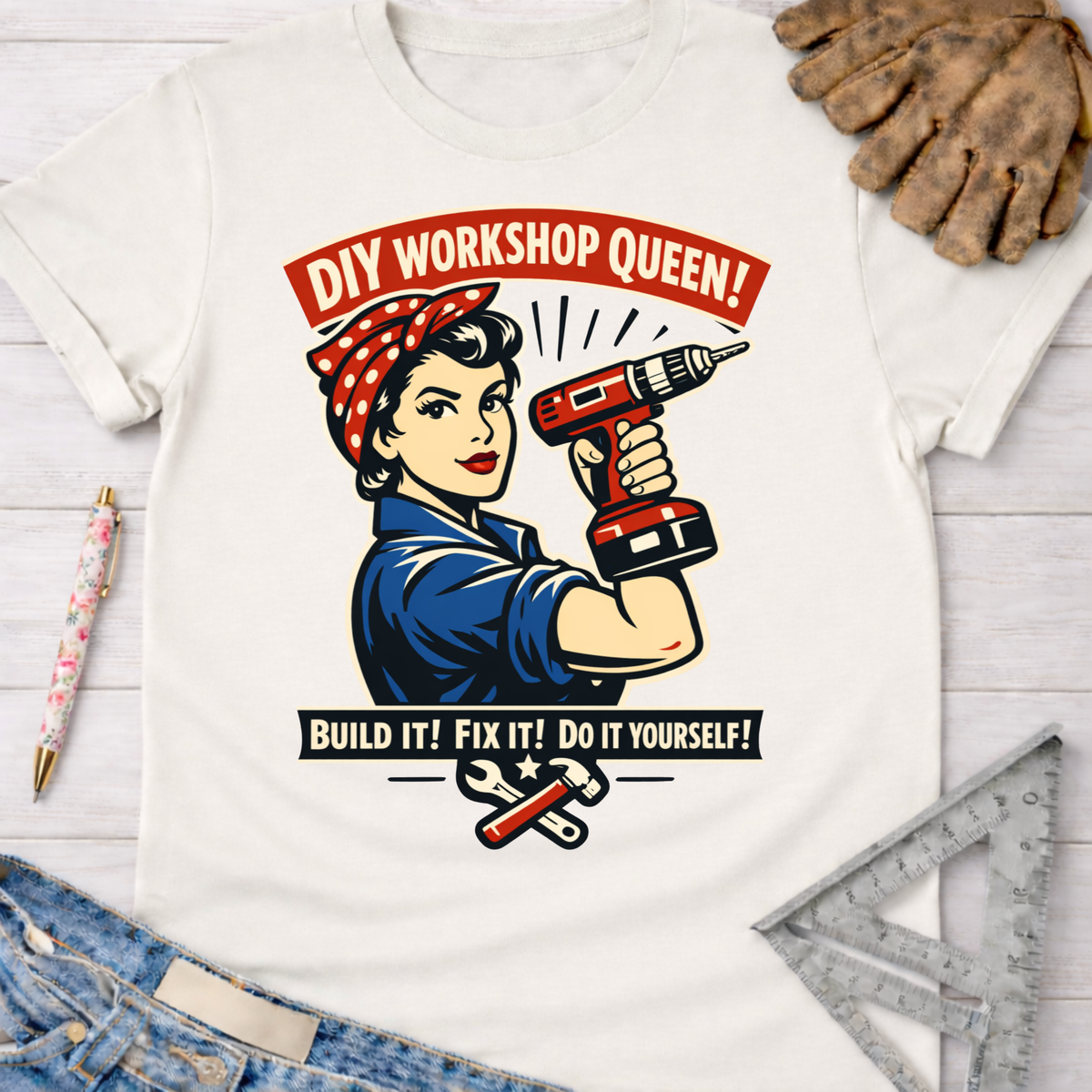 Women's funny woodworking graphic tee shirt for female woodworkers, makers, and DIY builders — Sawdust & Ponytails. White cotton t-shirt with Rosie the Riveter holding a drill, "DIY Workshop Queen!" and "Build It! Fix It! Do It Yourself!" text.