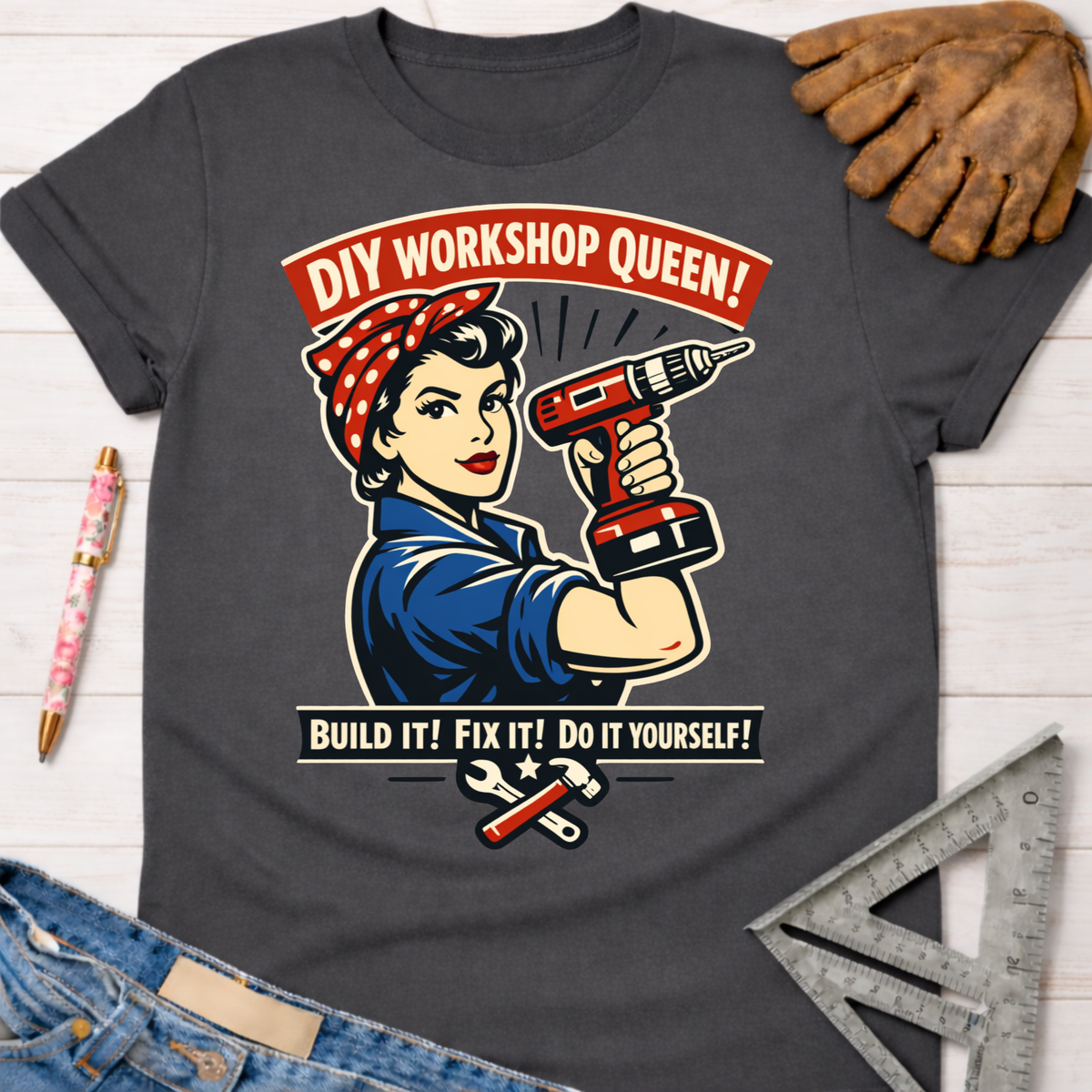 Women's funny woodworking graphic tee shirt for female woodworkers, makers, and DIY builders — Sawdust & Ponytails. Dark gray t-shirt with "DIY Workshop Queen!" Rosie the Riveter graphic holding a drill.