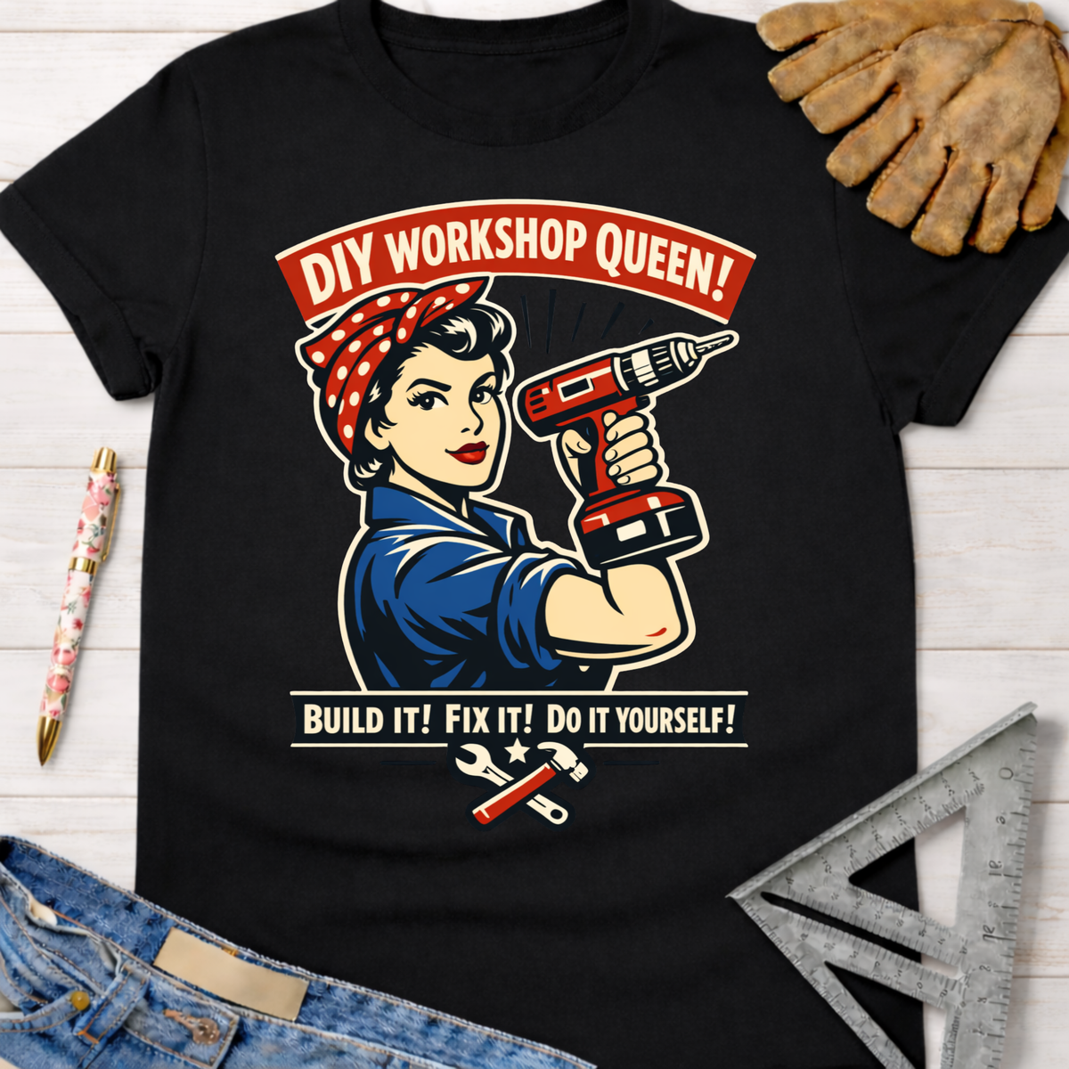 Women's funny woodworking graphic tee shirt for female woodworkers, makers, and DIY builders — Sawdust & Ponytails. Black cotton tee with Rosie the Riveter holding a drill, "DIY Workshop Queen!" and "Build It! Fix It! Do It Yourself!" text.