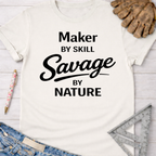 Women's funny woodworking graphic tee shirt for female woodworkers, makers, and DIY builders — Sawdust & Ponytails. White cotton tee with "Maker By Skill Savage By Nature" text.