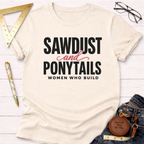Cream cotton t-shirt with "SAWDUST and PONYTAILS WOMEN WHO BUILD" in black and pink text.