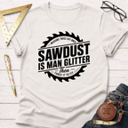 Cream cotton t-shirt with "Sawdust Is Man Glitter" graphic inside a saw blade design.
