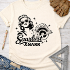 Cream women's funny woodworking graphic tee with "Sawdust & Sass" design, featuring a retro woman with a circular saw.