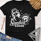 Black cotton "Sawdust & Sass" tee with a retro woman holding a circular saw. Women's funny woodworking graphic tee shirt for female woodworkers, makers, and DIY builders — Sawdust & Ponytails