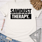 Women's funny woodworking graphic tee shirt for female woodworkers, makers, and DIY builders — Sawdust & Ponytails. White cotton tee with "SAWDUST THERAPY." in bold black text.