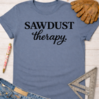 Women's funny woodworking graphic tee shirt for female woodworkers, makers, and DIY builders — Sawdust & Ponytails. Blue cotton tee with "SAWDUST therapy." in black script.