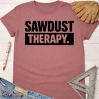 Women's funny woodworking graphic tee shirt for female woodworkers, makers, and DIY builders — Sawdust & Ponytails. Mauve cotton tee with "SAWDUST THERAPY." in black block letters.