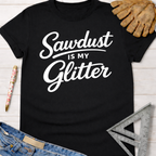 Women's funny woodworking graphic tee shirt for female woodworkers, makers, and DIY builders — Sawdust & Ponytails. Black tee with "Sawdust Is My Glitter" in white script.