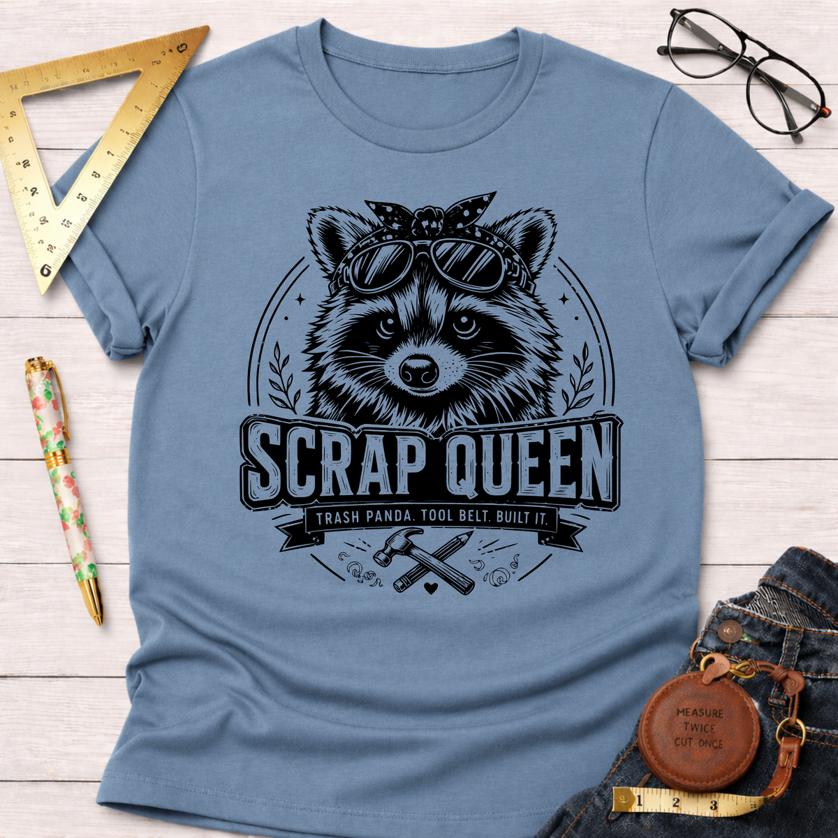Light blue cotton t-shirt with a "Scrap Queen" raccoon wearing sunglasses and a bandana design.