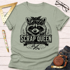 Sage green cotton t-shirt with a "Scrap Queen" raccoon wearing sunglasses and a bandana design.