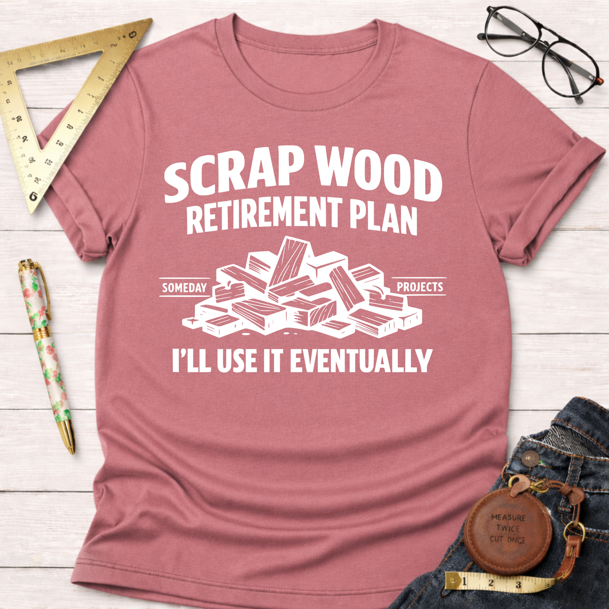 Heather mauve t-shirt with "Scrap Wood Retirement Plan" and a pile of wood scraps graphic in white.
