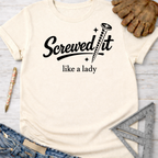 Women's funny woodworking graphic tee shirt for female woodworkers, makers, and DIY builders — Sawdust & Ponytails. Cream t-shirt with "Screwed It like a lady" text and screw graphic.