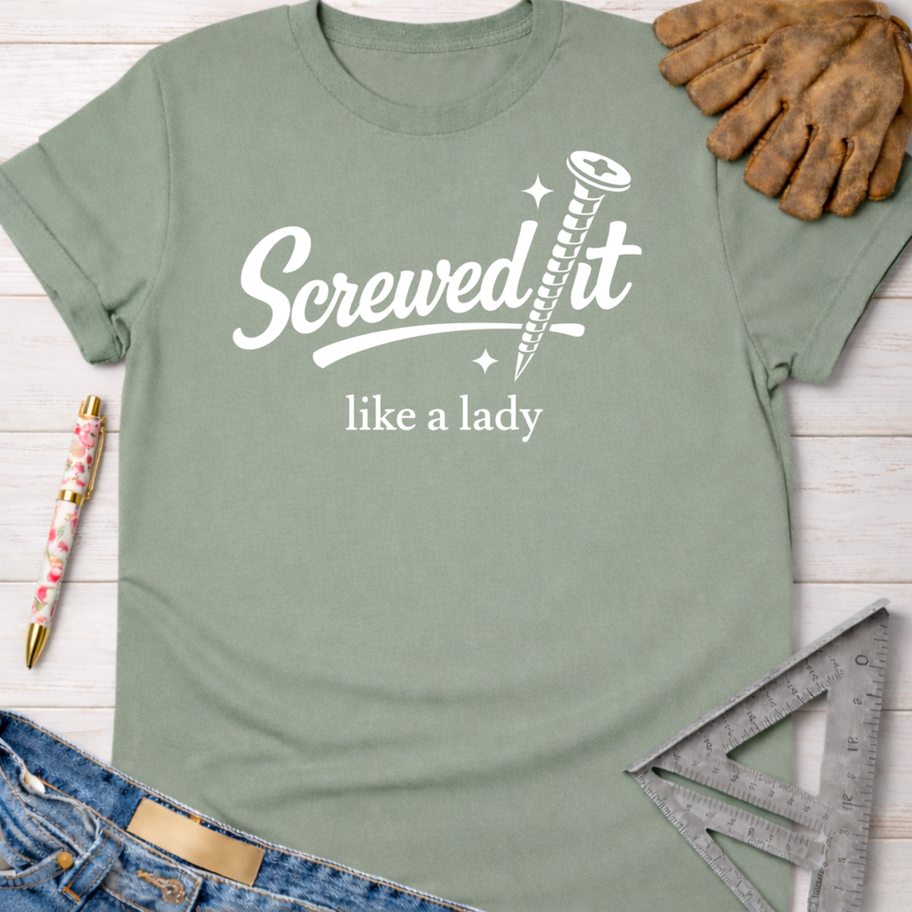 Women's funny woodworking graphic tee shirt for female woodworkers, makers, and DIY builders — Sawdust & Ponytails. Sage green cotton tee with "Screwed It like a lady" graphic.