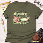 Olive green t-shirt with a scroll saw surrounded by pink peonies and white daisies.