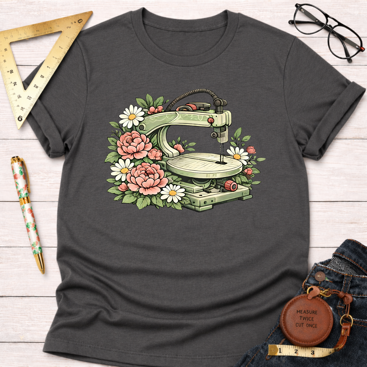 Charcoal gray t-shirt with a scroll saw surrounded by pink peonies and white daisies.
