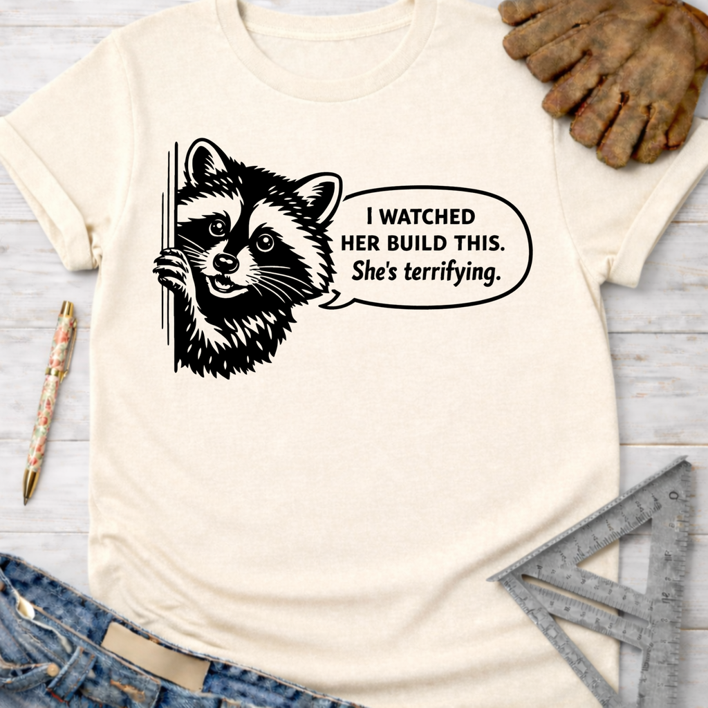 Cream "She's Terrifying" t-shirt with a raccoon graphic. Women's funny woodworking graphic tee shirt for female woodworkers, makers, and DIY builders — Sawdust & Ponytails