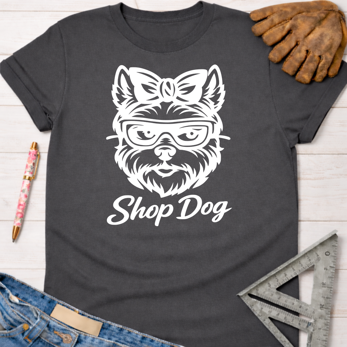 Women's funny woodworking graphic tee shirt for female woodworkers, makers, and DIY builders — Sawdust & Ponytails. Dark gray tee with white "Shop Dog" graphic.