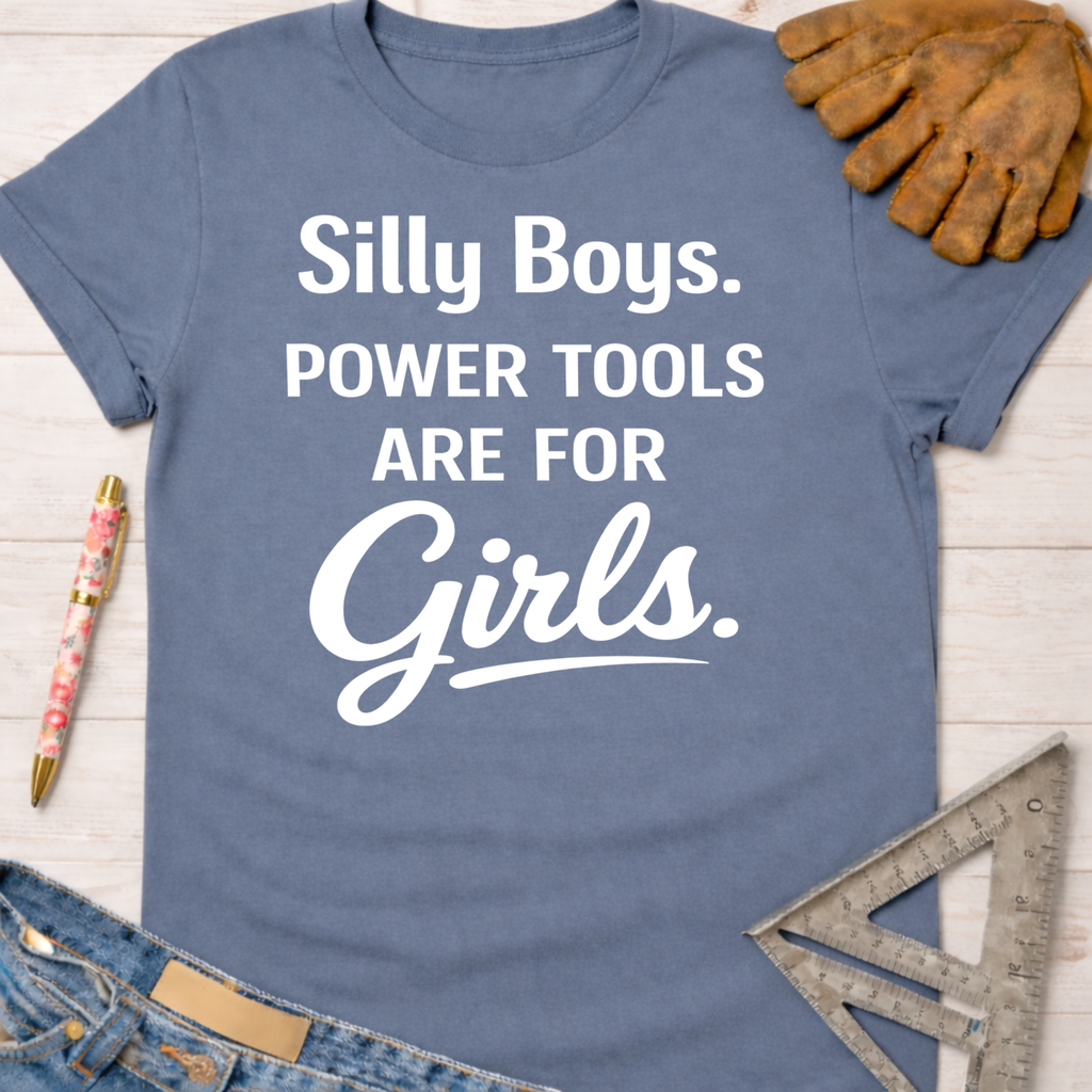 Women's funny woodworking graphic tee shirt for female woodworkers, makers, and DIY builders — Sawdust & Ponytails. Blue cotton tee with "Silly Boys. Power Tools Are For Girls." in white text.