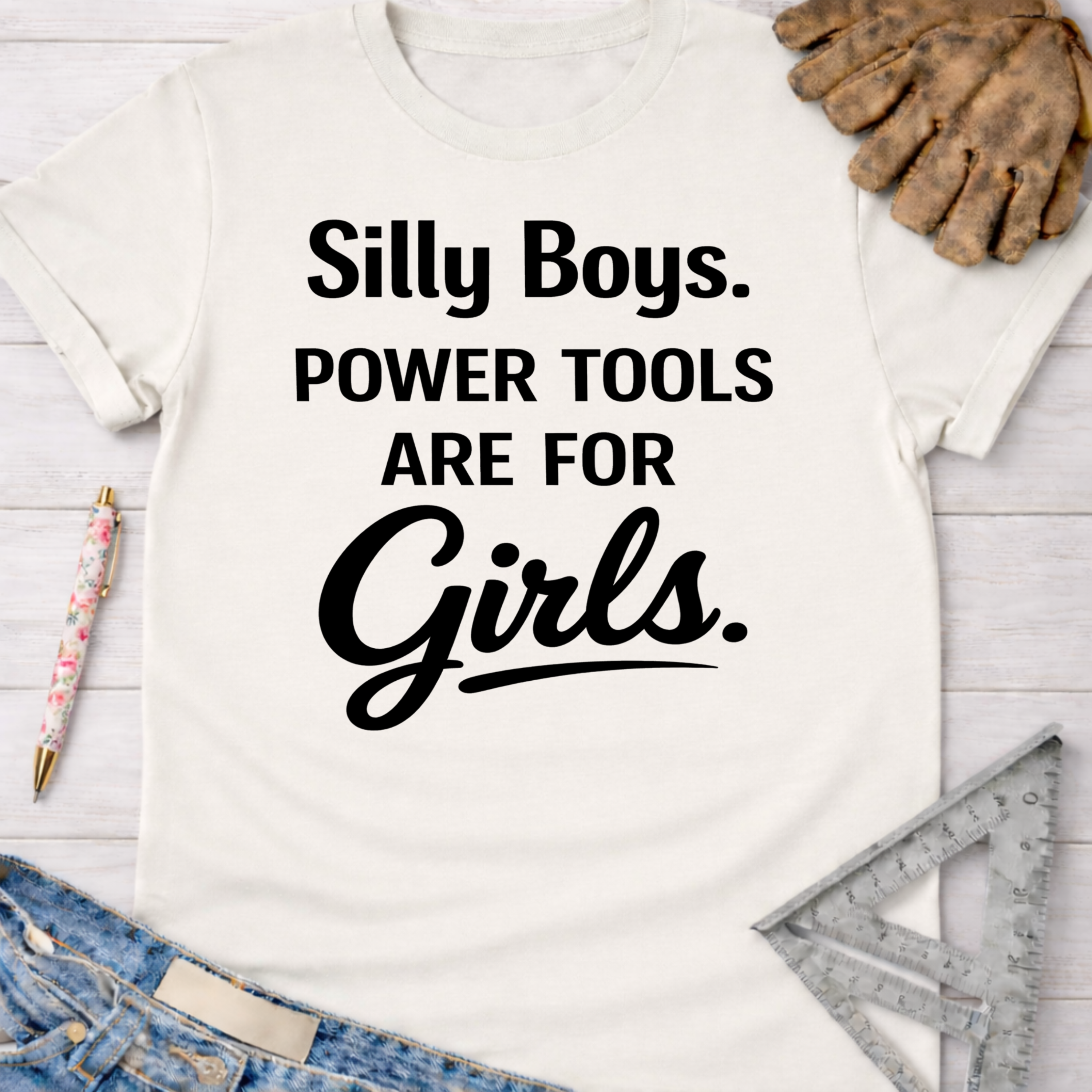 Women's funny woodworking graphic tee shirt for female woodworkers, makers, and DIY builders — Sawdust & Ponytails. White cotton tee with "Silly Boys. Power Tools Are For Girls." in black text.