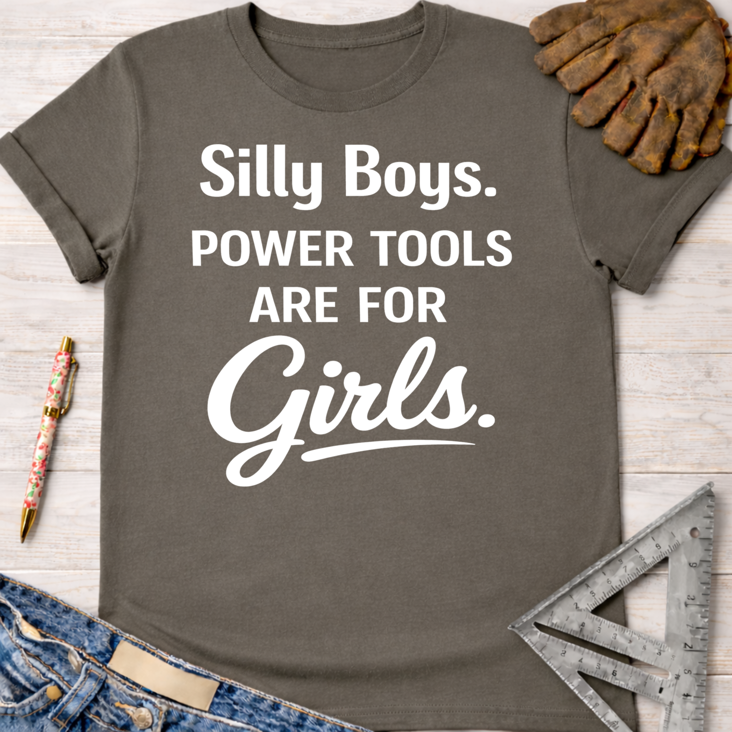 Women's funny woodworking graphic tee shirt for female woodworkers, makers, and DIY builders — Sawdust & Ponytails. Dark gray t-shirt with "Silly Boys. Power Tools Are For Girls." in white text.