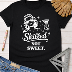 Women's funny woodworking graphic tee shirt for female woodworkers, makers, and DIY builders — Sawdust & Ponytails. Black cotton tee with "Skilled Not Sweet" graphic.