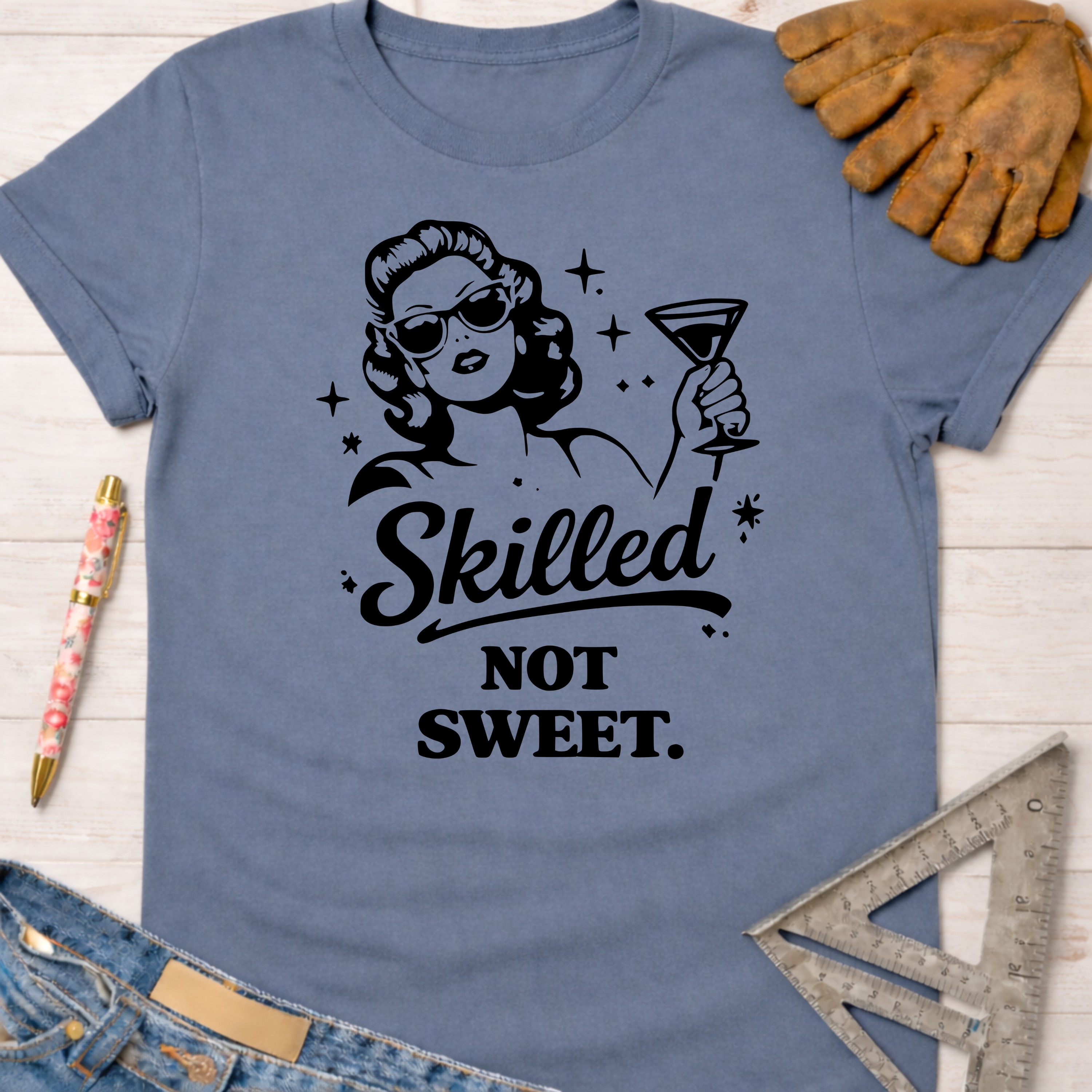 Women's funny woodworking graphic tee shirt for female woodworkers, makers, and DIY builders — Sawdust & Ponytails. Blue cotton t-shirt with "Skilled Not Sweet" graphic.