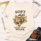 Cream t-shirt with "Soft Doesn't Mean Weak" text, a hammer, and pink floral design.