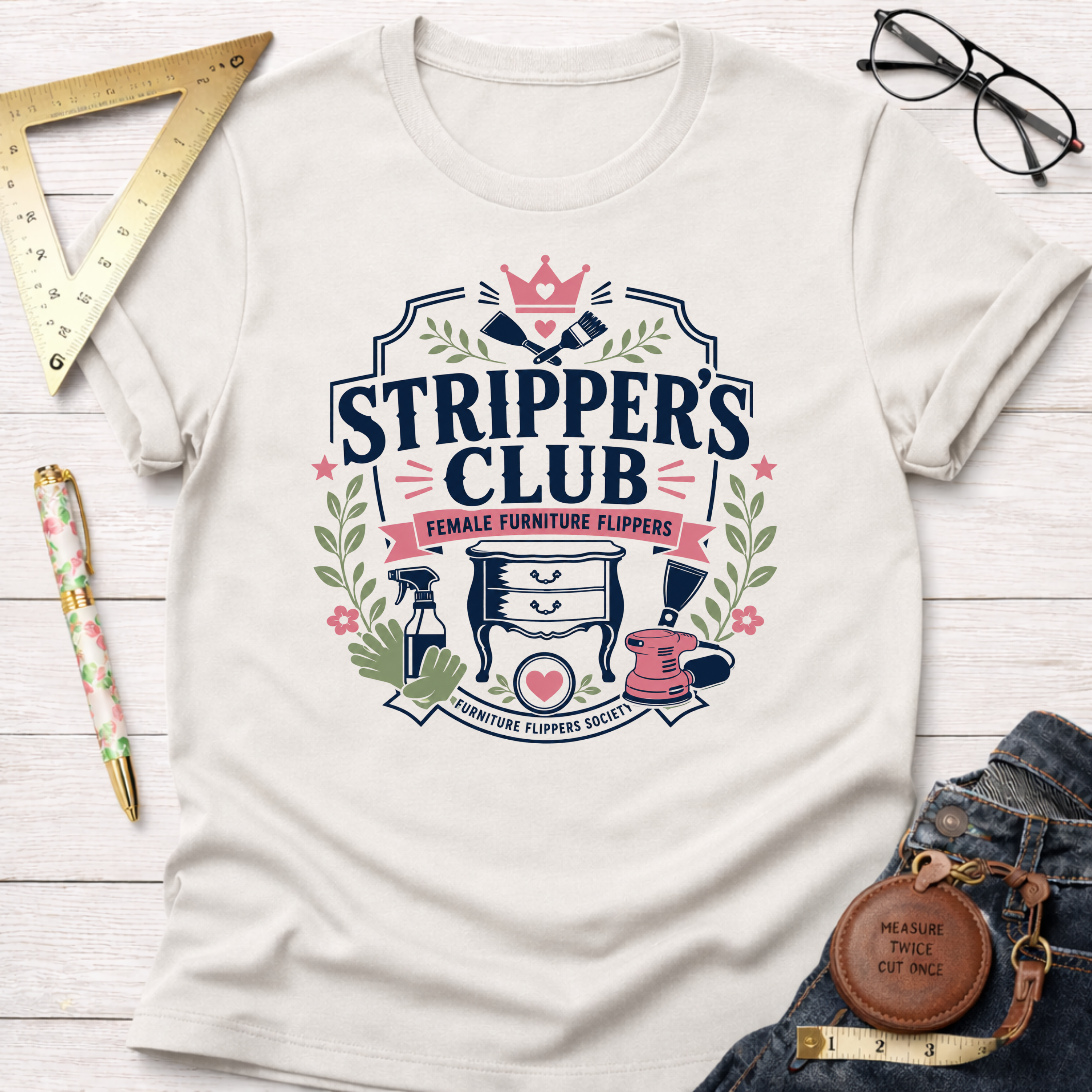Off-white cotton t-shirt with "Stripper's Club Female Furniture Flippers" graphic, surrounded by tools.
