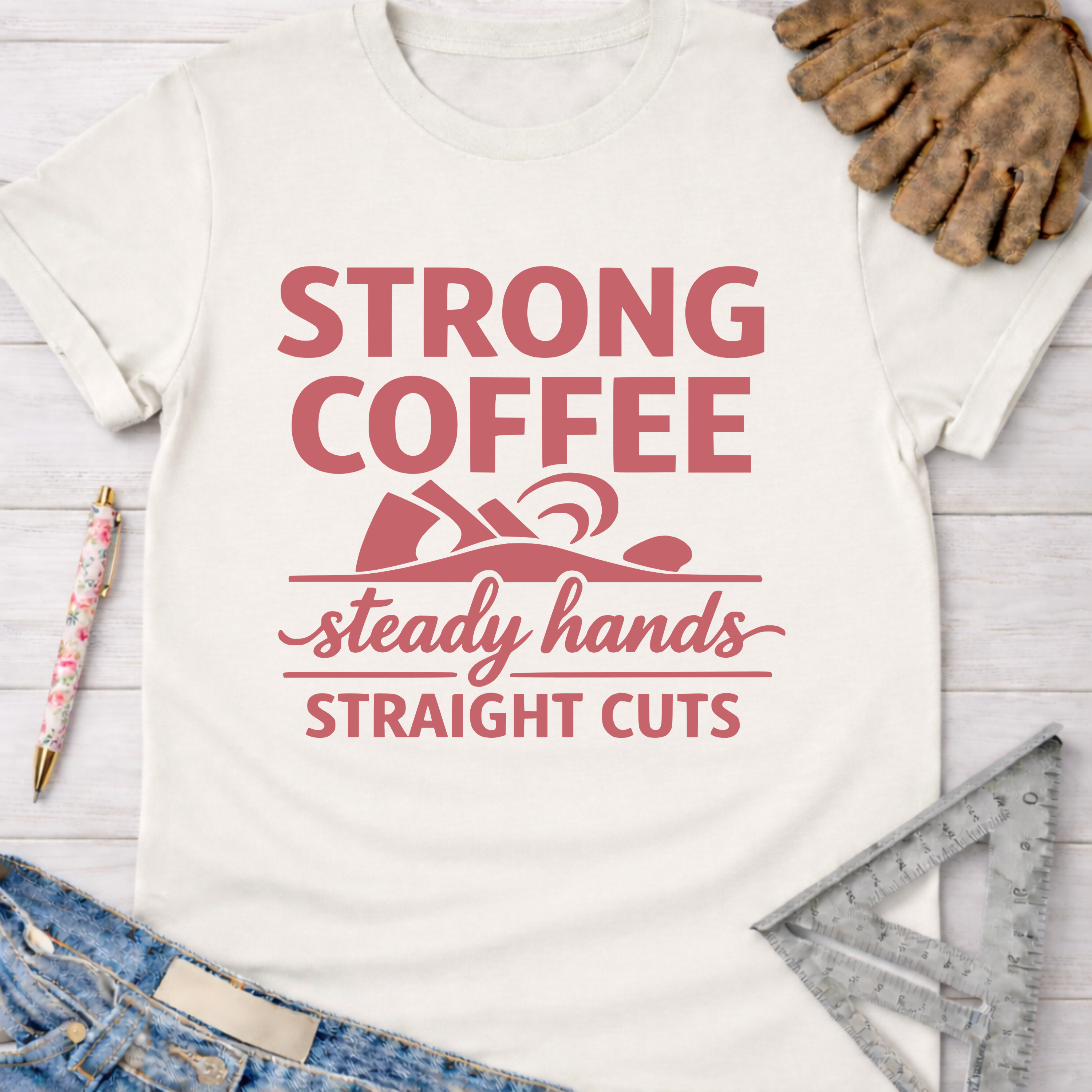 Women's funny woodworking graphic tee shirt for female woodworkers, makers, and DIY builders — Sawdust & Ponytails. White cotton tee with "Strong Coffee Steady Hands Straight Cuts" in red.