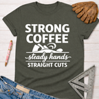 Women's funny woodworking graphic tee shirt for female woodworkers, makers, and DIY builders — Sawdust & Ponytails. Dark gray t-shirt with "Strong Coffee, Steady Hands, Straight Cuts" design.