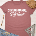 Women's funny woodworking graphic tee shirt for female woodworkers, makers, and DIY builders — Sawdust & Ponytails. Mauve short-sleeve t-shirt with "Strong Hands. Soft Heart." in white text.
