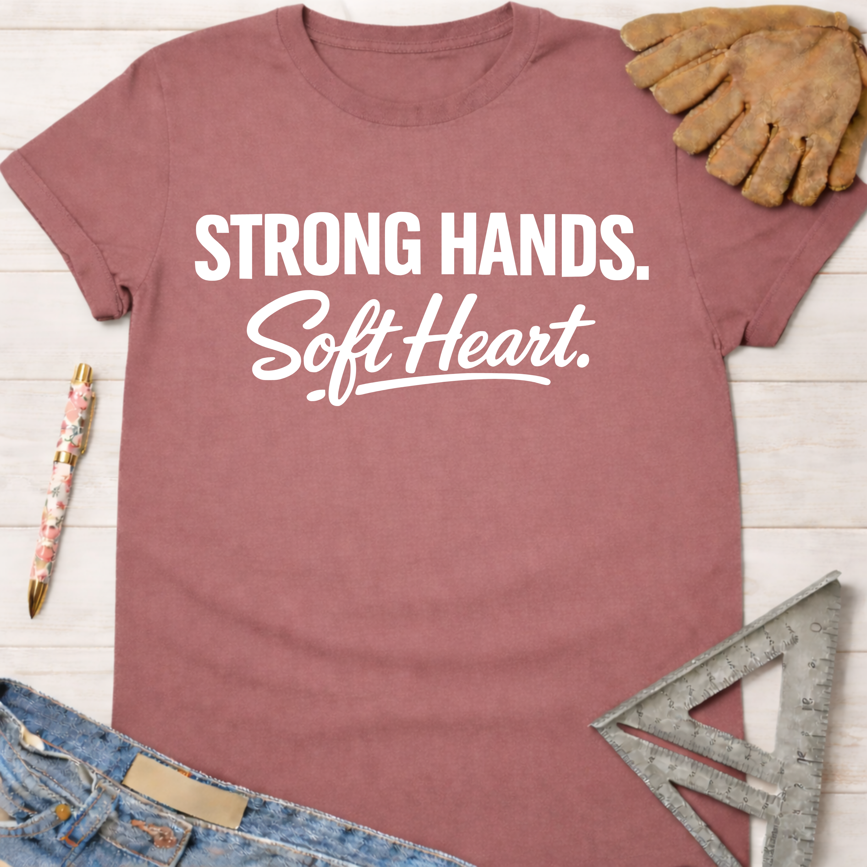 Women's funny woodworking graphic tee shirt for female woodworkers, makers, and DIY builders — Sawdust & Ponytails. Mauve short-sleeve t-shirt with "Strong Hands. Soft Heart." in white text.