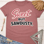 Women's funny woodworking graphic tee shirt for female woodworkers, makers, and DIY builders — Sawdust & Ponytails. Mauve cotton tee with "Sweet But Sawdusty" in pink and white script.