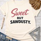 Women's funny woodworking graphic tee shirt for female woodworkers, makers, and DIY builders — Sawdust & Ponytails. Cream t-shirt with "Sweet BUT SAWDUSTY" in pink and black.