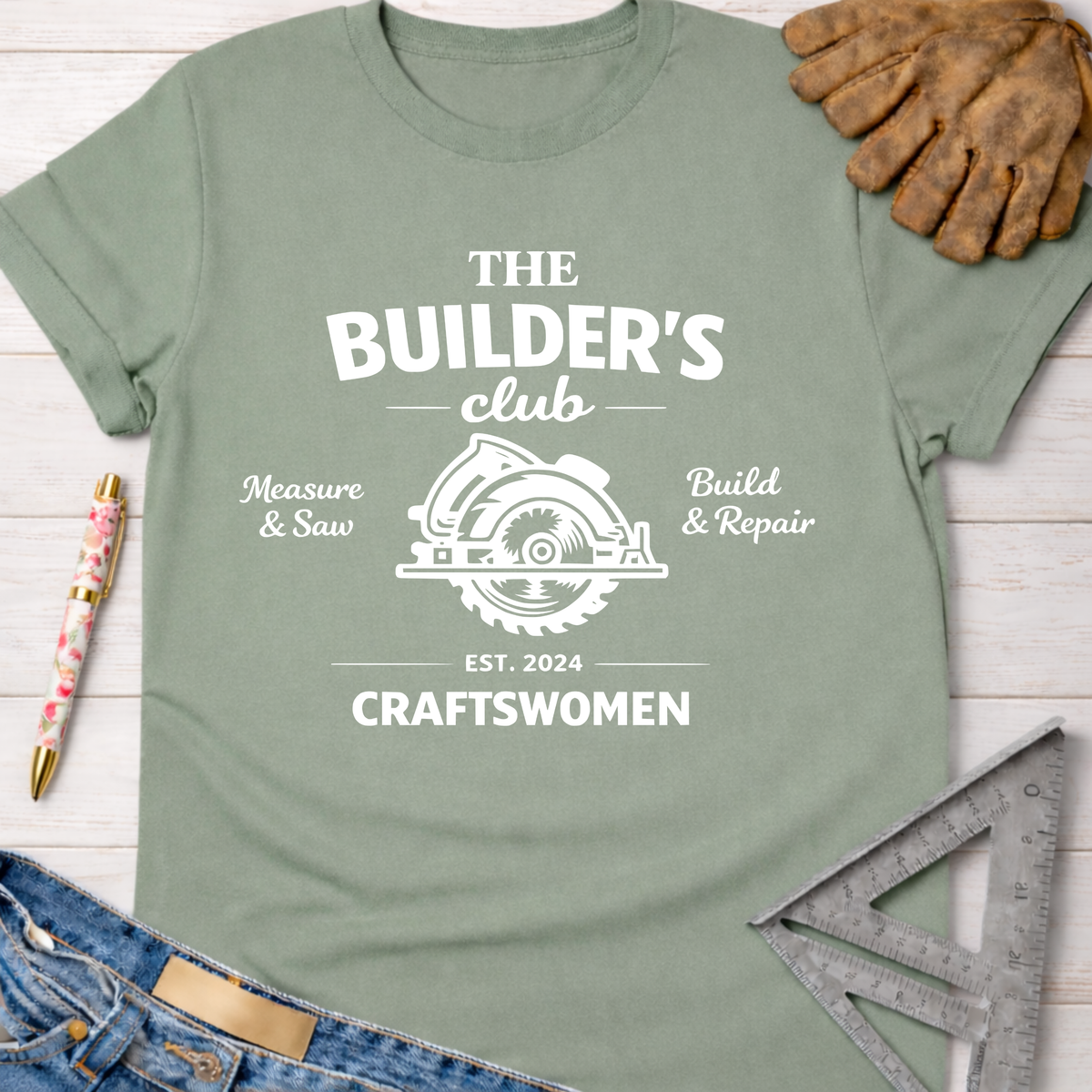 Women's funny woodworking graphic tee shirt for female woodworkers, makers, and DIY builders — Sawdust & Ponytails. Sage green cotton t-shirt with "The Builder's Club" circular saw graphic.