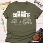 Olive green cotton t-shirt with "THE DAILY COMMUTE" text and a stick figure walking from house to workshop graphic.