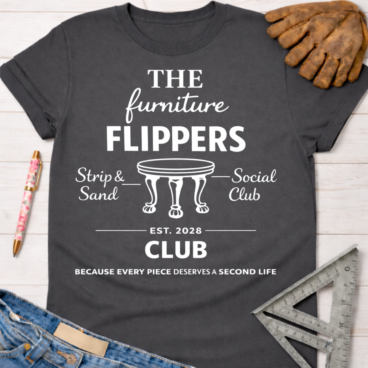 Women's funny woodworking graphic tee shirt for female woodworkers, makers, and DIY builders — Sawdust & Ponytails. Dark gray cotton tee with "The Furniture Flippers Social Club" graphic.