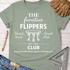 Women's funny woodworking graphic tee shirt for female woodworkers, makers, and DIY builders — Sawdust & Ponytails. Sage green cotton tee with "The Furniture Flippers Social Club" graphic.