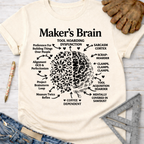 Women's funny woodworking graphic tee shirt for female woodworkers, makers, and DIY builders — Sawdust & Ponytails. Cream t-shirt with "Maker's Brain" diagram.
