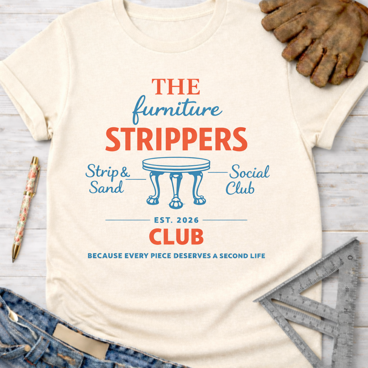 Women's funny woodworking graphic tee shirt for female woodworkers, makers, and DIY builders — Sawdust & Ponytails. Cream t-shirt with "The Furniture Strippers Social Club" graphic.