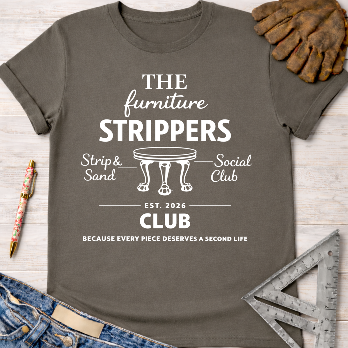 Charcoal gray women's funny woodworking graphic tee with "The Furniture Strippers Social Club" design, Sawdust & Ponytails.