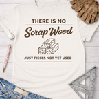 Women's funny woodworking graphic tee shirt for female woodworkers, makers, and DIY builders — Sawdust & Ponytails. Cream cotton tee with "THERE IS NO Scrap Wood JUST PIECES NOT YET USED" graphic.