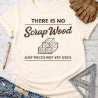 Women's funny woodworking graphic tee shirt for female woodworkers, makers, and DIY builders — Sawdust & Ponytails. Cream t-shirt with "There Is No Scrap Wood Just Pieces Not Yet Used" graphic.