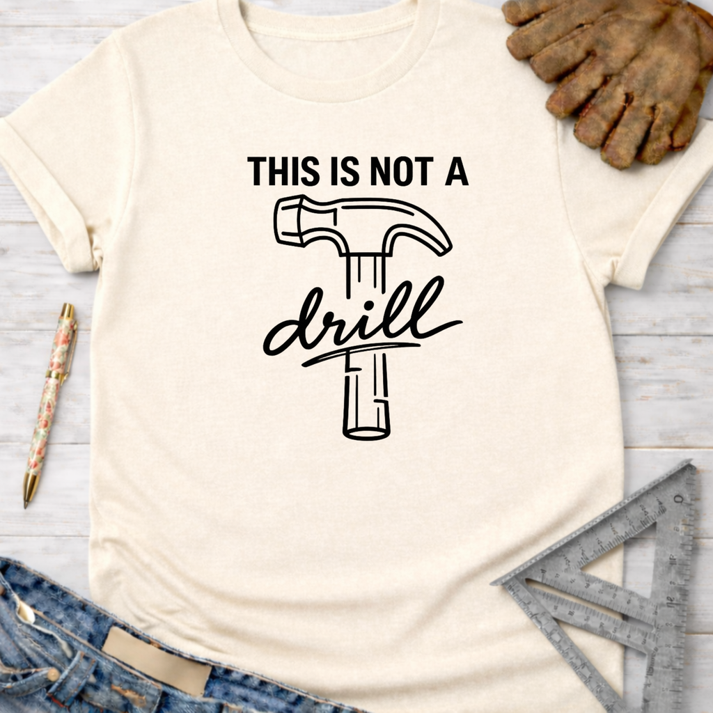 Women's funny woodworking graphic tee shirt for female woodworkers, makers, and DIY builders — Sawdust & Ponytails. Cream short-sleeve tee with "THIS IS NOT A drill" hammer graphic.