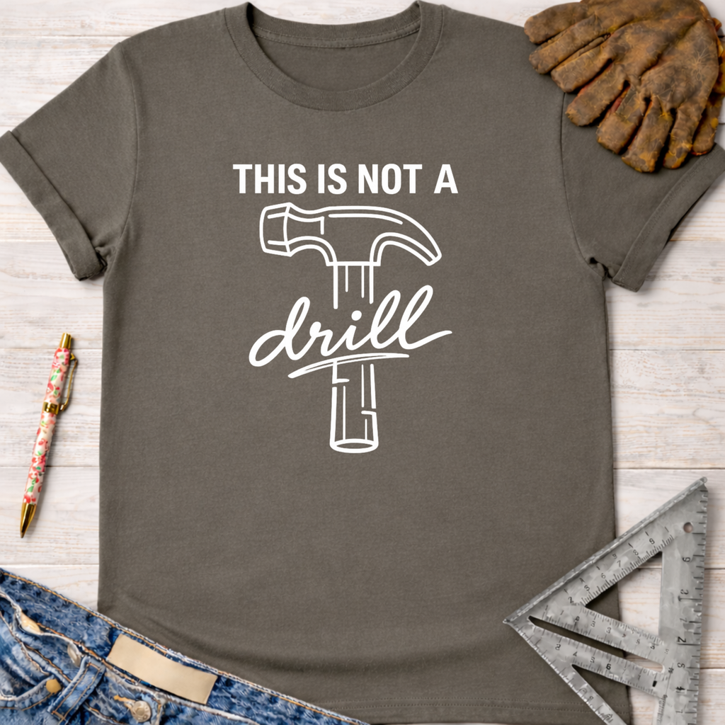 Women's funny woodworking graphic tee shirt for female woodworkers, makers, and DIY builders — Sawdust & Ponytails. Dark gray cotton t-shirt with "THIS IS NOT A drill" text and hammer graphic.