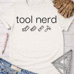 Women's funny woodworking graphic tee shirt for female woodworkers, makers, and DIY builders — Sawdust & Ponytails. White short-sleeve t-shirt with "tool nerd" and four tool icons.