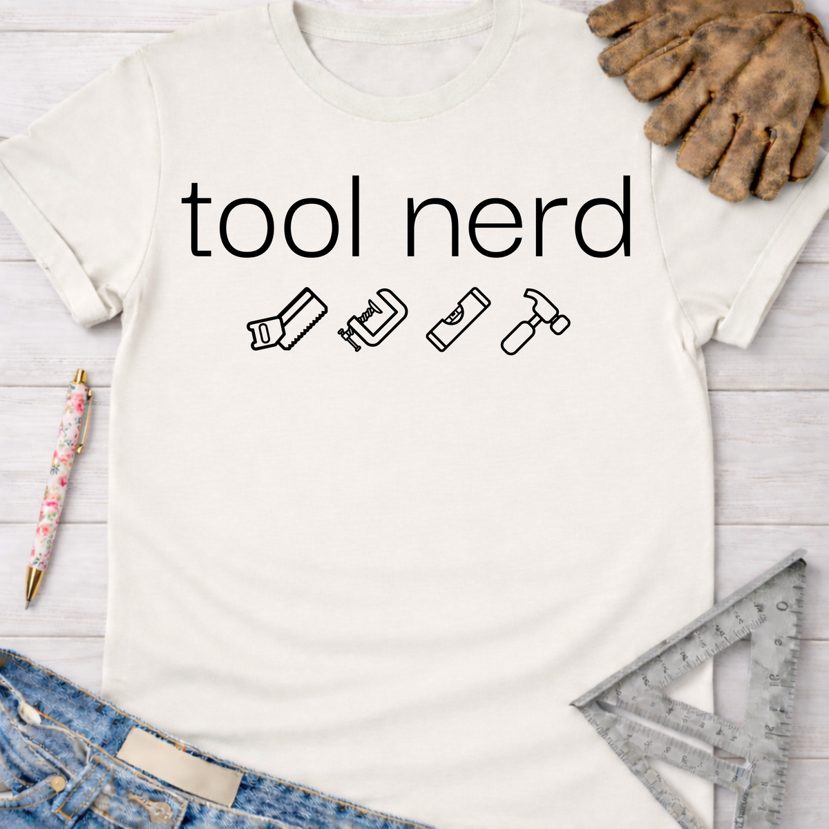 Women's funny woodworking graphic tee shirt for female woodworkers, makers, and DIY builders — Sawdust & Ponytails. White short-sleeve t-shirt with "tool nerd" and four tool icons.