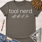 Women's funny woodworking graphic tee shirt for female woodworkers, makers, and DIY builders — Sawdust & Ponytails. Dark gray cotton t-shirt with "tool nerd" text and tool icons.